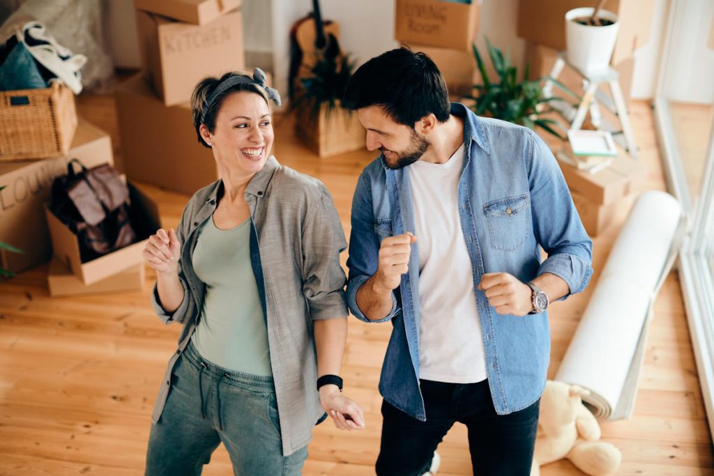 Couple dancing while moving into their new home